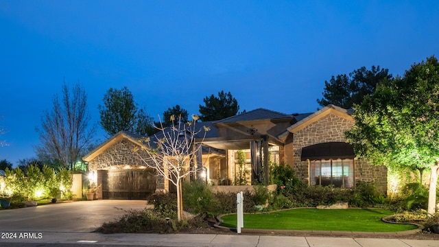 mediterranean / spanish-style house featuring a front yard and a garage