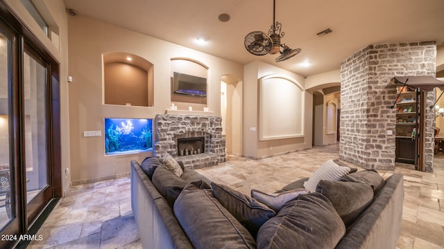 living room with a stone fireplace