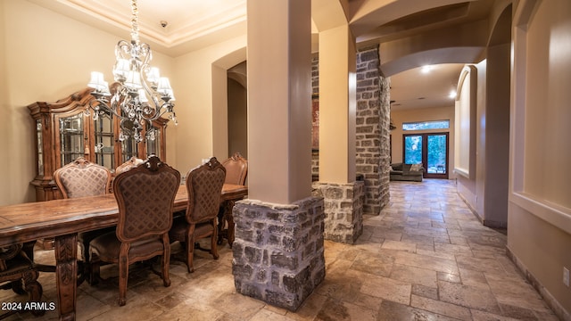 dining room with a notable chandelier and crown molding