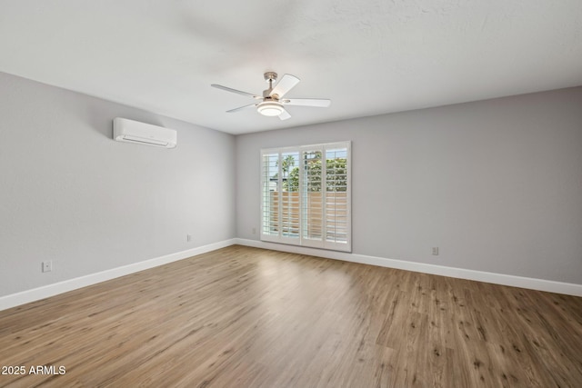 18548 E Parada Cir, Rio Verde, AZ 85263 - spare room with light wood-type flooring, a wall mounted AC, and baseboards