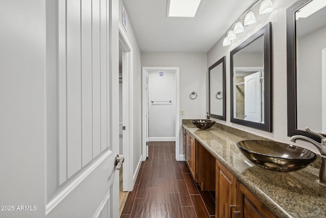18548 E Parada Cir, Rio Verde, AZ 85263 - full bath with double vanity, baseboards, a sink, and wood finished floors