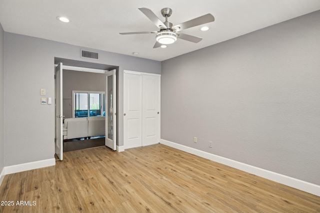 18548 E Parada Cir, Rio Verde, AZ 85263 - unfurnished bedroom featuring light wood-style floors, recessed lighting, visible vents, and baseboards