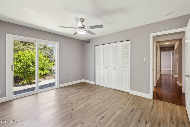 18548 E Parada Cir, Rio Verde, AZ 85263 - unfurnished bedroom featuring visible vents, access to outside, baseboards, and wood finished floors
