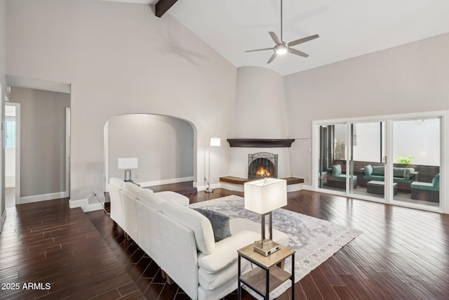 18548 E Parada Cir, Rio Verde, AZ 85263 - living room with baseboards, arched walkways, ceiling fan, wood finished floors, and high vaulted ceiling