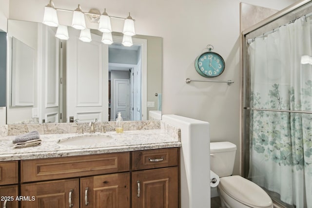 bathroom featuring walk in shower, vanity, and toilet