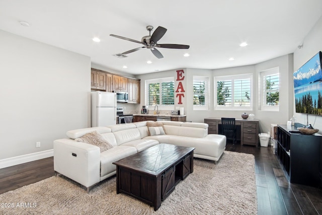 living room with hardwood / wood-style floors, sink, plenty of natural light, and ceiling fan