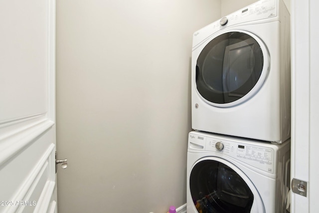 laundry room with stacked washer and clothes dryer