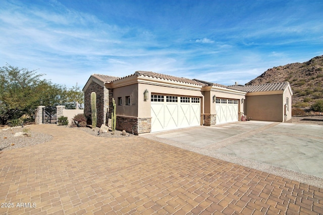 mediterranean / spanish home with a garage