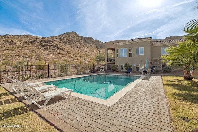 view of pool with a mountain view and a patio area