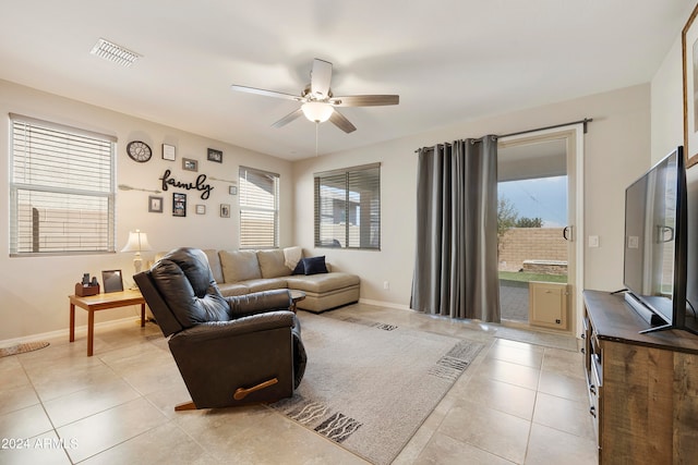 living room with plenty of natural light, light tile patterned flooring, and ceiling fan