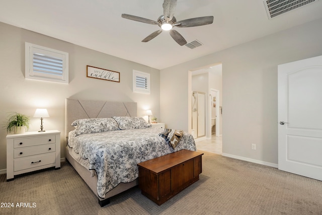 bedroom with ceiling fan, carpet floors, and ensuite bath