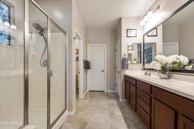 bathroom featuring vanity and a shower with shower door