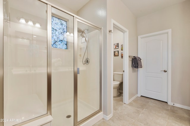 bathroom featuring toilet, tile patterned floors, and walk in shower