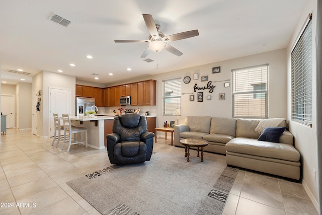 tiled living room with ceiling fan