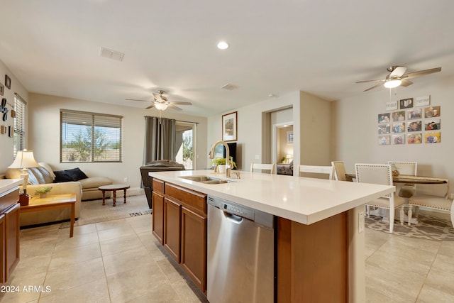 kitchen featuring a center island with sink, dishwasher, ceiling fan, and sink