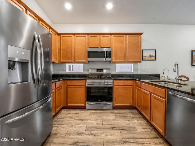 7648 S Thimble Peak, Gold Canyon, AZ 85118 - kitchen featuring appliances with stainless steel finishes, a sink, light wood-style flooring, brown cabinets, and recessed lighting