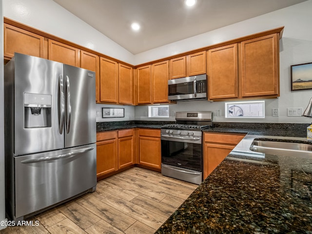 7648 S Thimble Peak, Gold Canyon, AZ 85118 - kitchen with stainless steel appliances, light wood-style flooring, brown cabinets, dark stone countertops, and recessed lighting