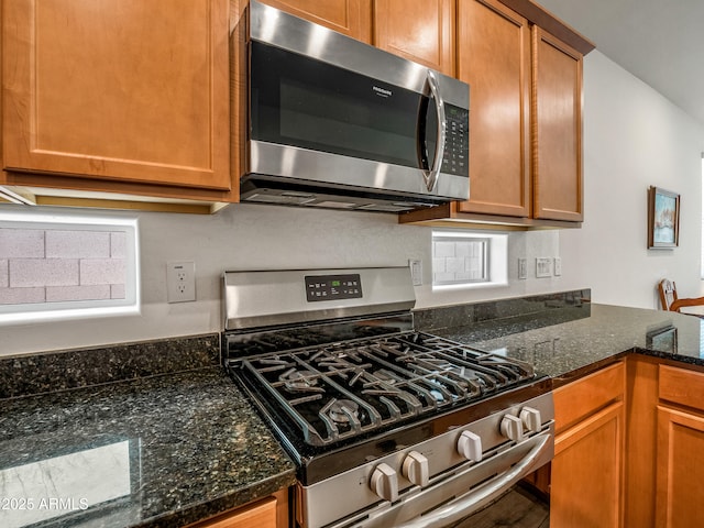7648 S Thimble Peak, Gold Canyon, AZ 85118 - kitchen with appliances with stainless steel finishes, dark stone countertops, and brown cabinets