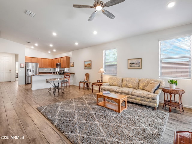 7648 S Thimble Peak, Gold Canyon, AZ 85118 - living area with a ceiling fan, vaulted ceiling, light wood finished floors, recessed lighting, and baseboards
