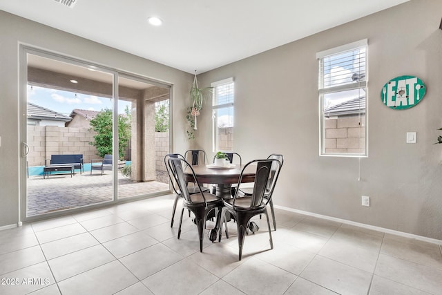 dining space featuring light tile patterned floors, baseboards, and recessed lighting