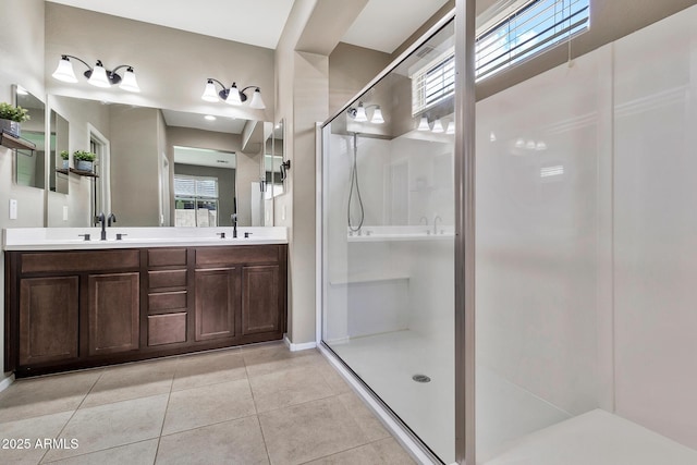 full bathroom with tile patterned floors, a shower stall, double vanity, and a sink