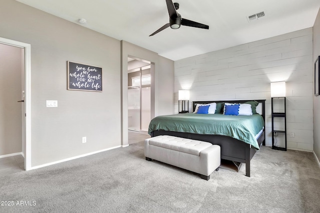 carpeted bedroom with visible vents, ceiling fan, ensuite bath, and baseboards