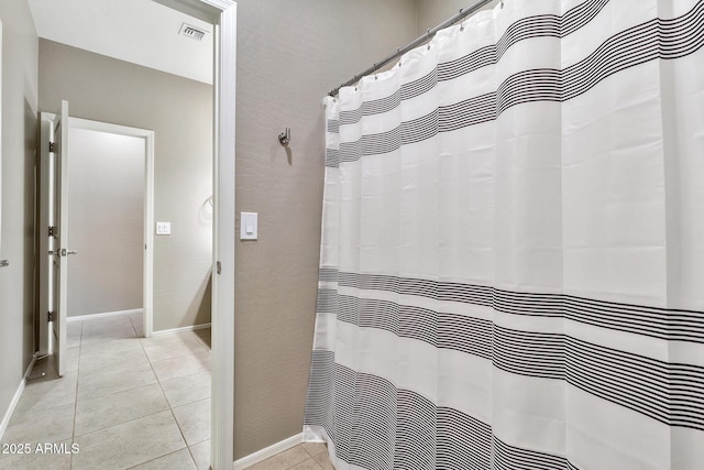 bathroom with tile patterned floors, baseboards, and visible vents