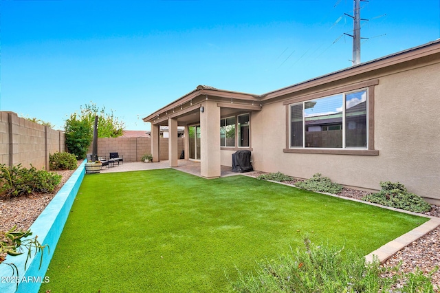 view of yard with a patio area and a fenced backyard