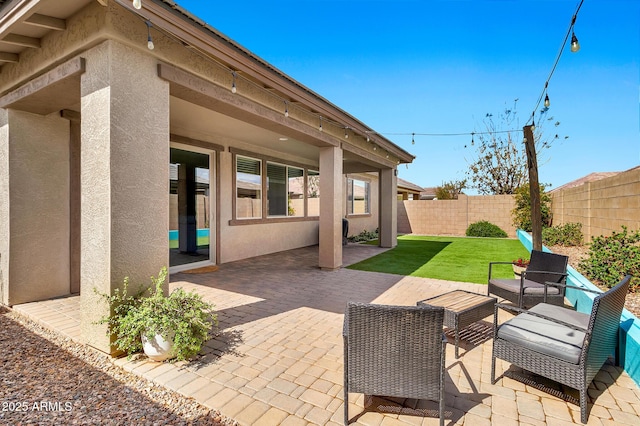 view of patio with an outdoor living space and a fenced backyard