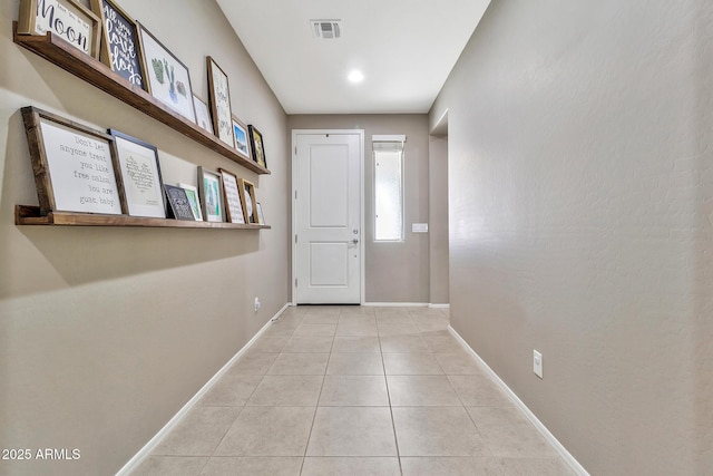 entryway with tile patterned flooring, baseboards, and visible vents