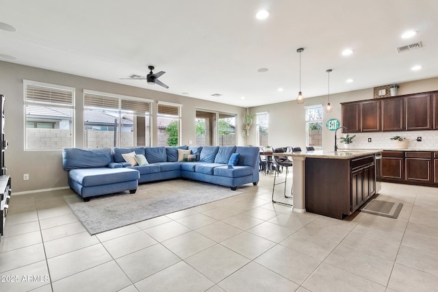 living room featuring light tile patterned flooring, recessed lighting, visible vents, and baseboards