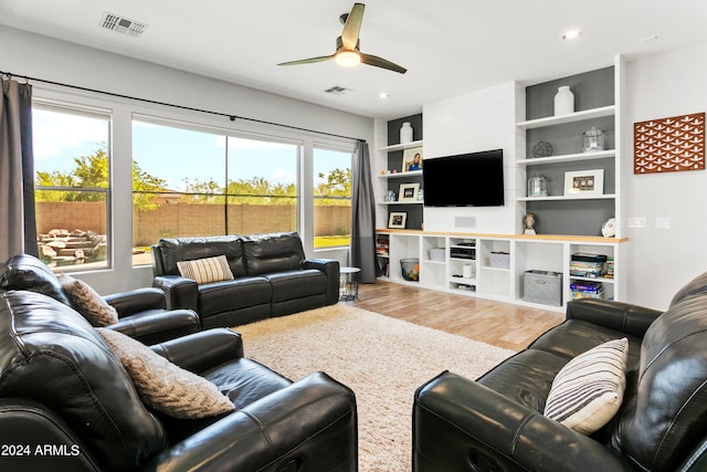 living room featuring hardwood / wood-style flooring and ceiling fan