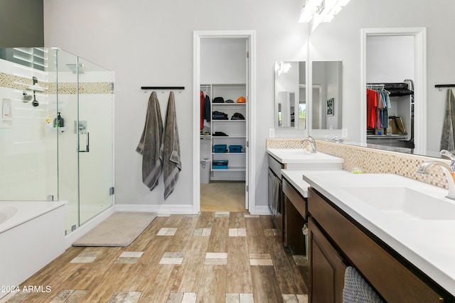 bathroom with vanity, hardwood / wood-style floors, and shower with separate bathtub