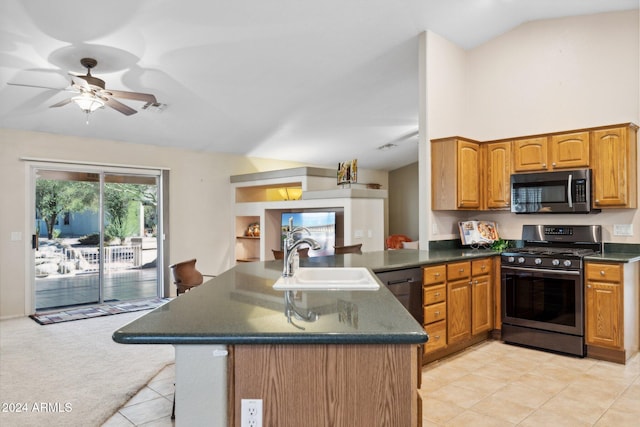 kitchen featuring kitchen peninsula, stainless steel appliances, sink, vaulted ceiling, and ceiling fan