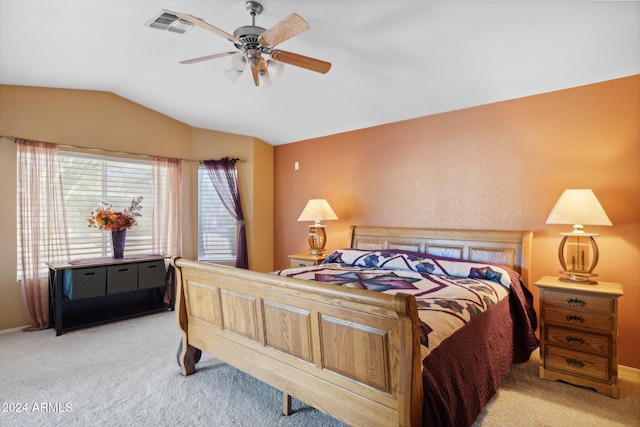 bedroom featuring light carpet, lofted ceiling, and ceiling fan