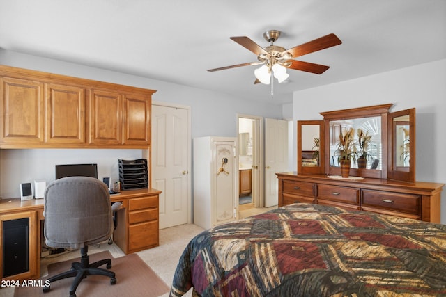 bedroom with light carpet, ensuite bathroom, and ceiling fan