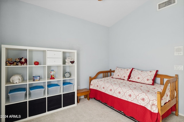 bedroom with lofted ceiling and carpet floors