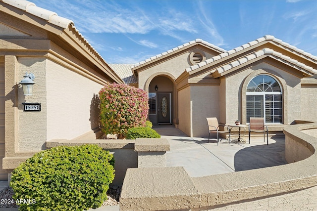 entrance to property featuring a patio area