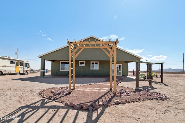 rear view of property featuring a patio area and stucco siding