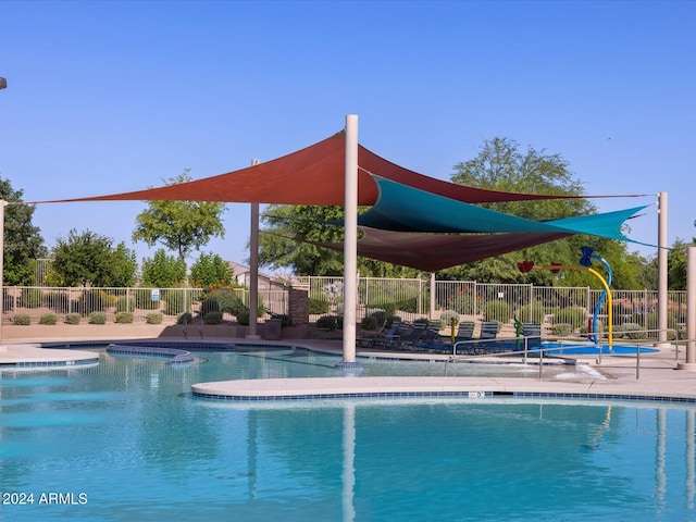 view of swimming pool with a hot tub