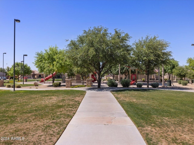 surrounding community featuring a yard and a playground