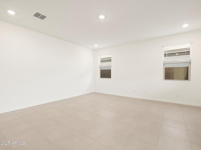 spare room featuring light tile patterned flooring