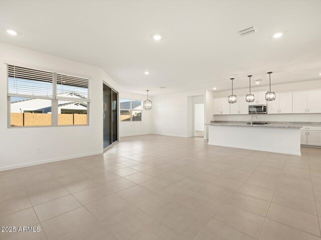 unfurnished living room featuring light tile patterned flooring