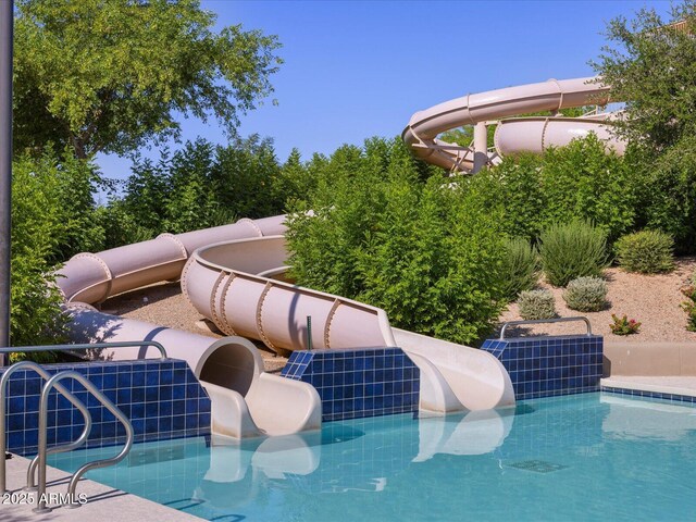 view of swimming pool featuring a water slide