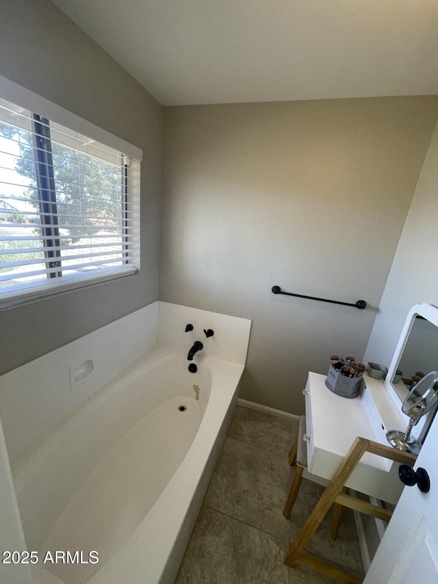 bathroom with a garden tub and tile patterned floors