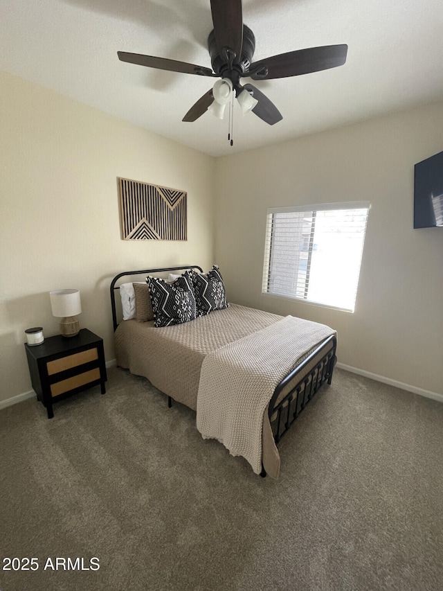 carpeted bedroom with baseboards and a ceiling fan