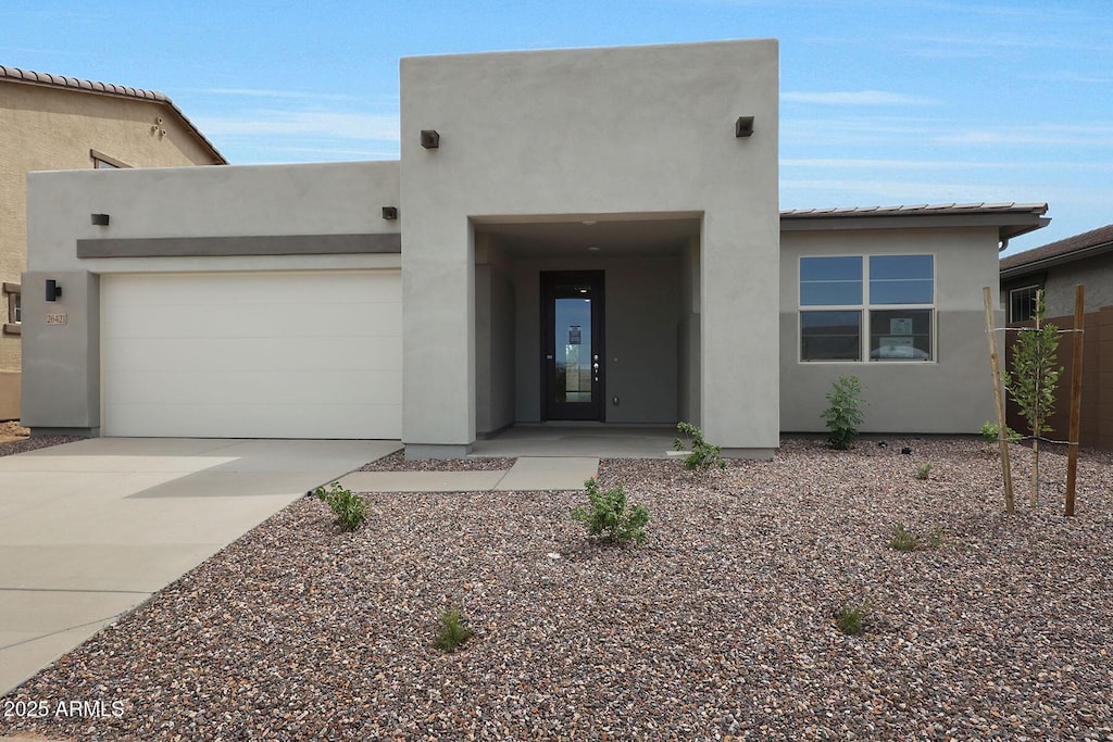 pueblo-style house with a garage