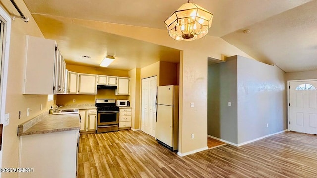 kitchen featuring white appliances, extractor fan, a sink, light wood-style flooring, and a chandelier