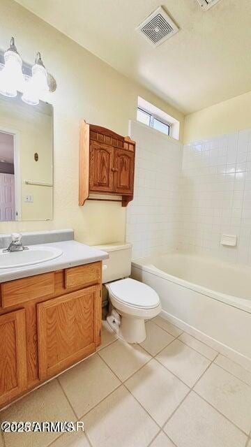 bathroom featuring tile patterned flooring, toilet, vanity, and shower / bathtub combination