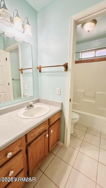 bathroom featuring tile patterned flooring, vanity, toilet, and washtub / shower combination